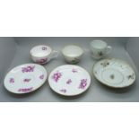 A 19th Century fine porcelain cup and two saucers and a Georgian fine porcelain trio, painted and