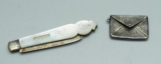 A Victorian silver bladed fruit knife with mother of pearl handle and a sterling silver stamp case