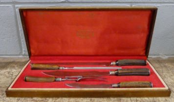 A Stag Horn four-piece carving set by Lewis and Co., cased