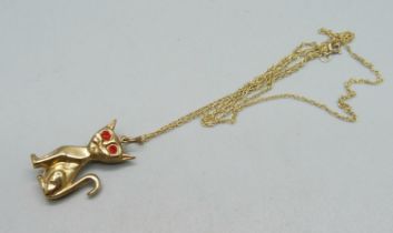 A hallmarked 9ct gold cat pendant or charm with gem set eyes and on a fine 9ct gold chain, 2.3g