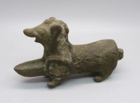 A small cast iron oil burner in the form of a dog
