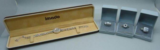 Three silver rings and a lady's cocktail wristwatch