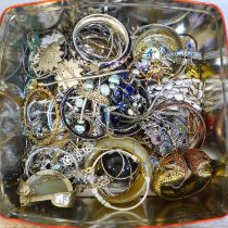 A tin of costume jewellery