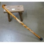 A wooden stool and walking stick with dragon motif