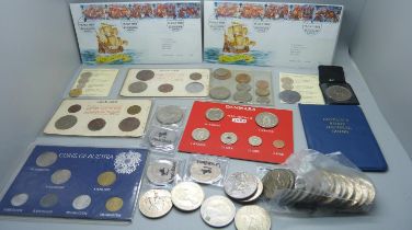 A collection of coins and coin sets including two reproduction Armada coins, crowns, etc.