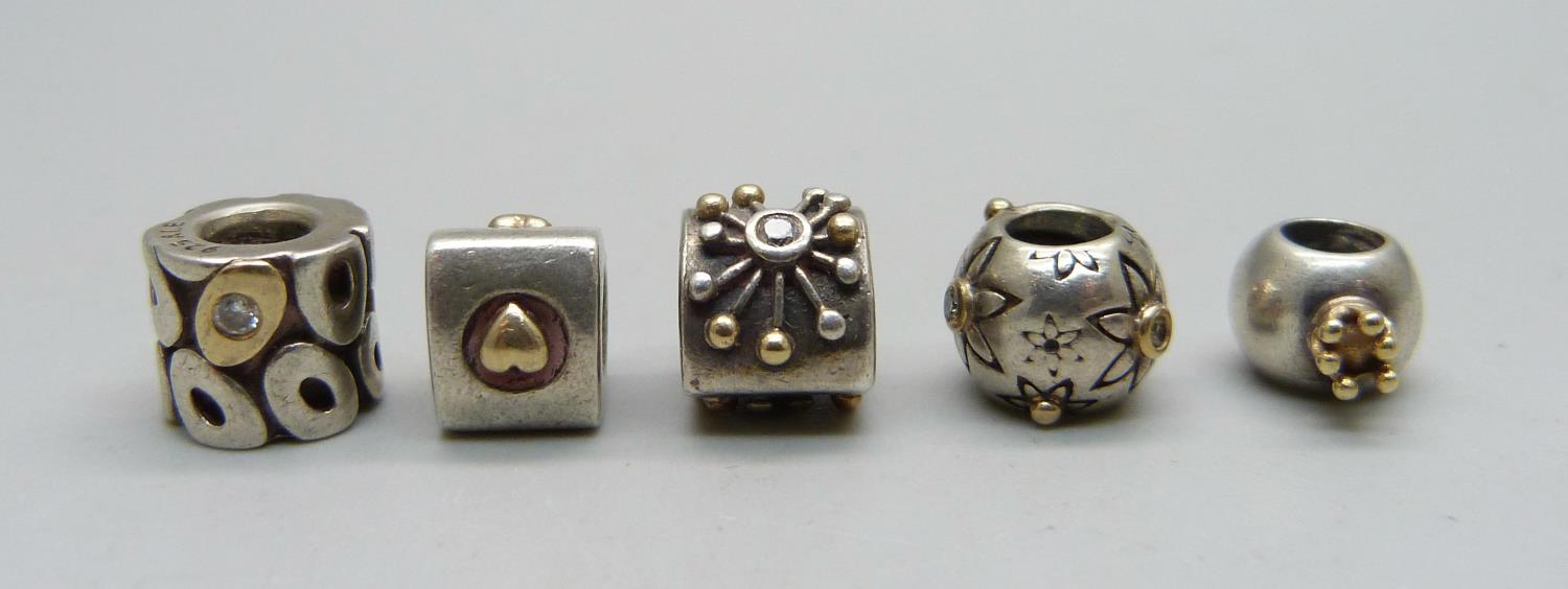 Five Pandora silver charms, all with applied gold and three also set with diamonds, (including
