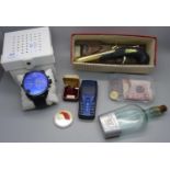 A Diesel wristwatch, a/f, a novelty lighter, a Cognac flask, coins and two bank notes