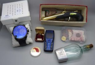 A Diesel wristwatch, a/f, a novelty lighter, a Cognac flask, coins and two bank notes