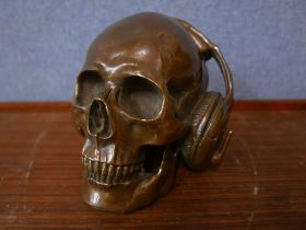A bronze skull wearing headphones