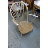 An Ercol Blonde elm and beech Chairmaker's armchair