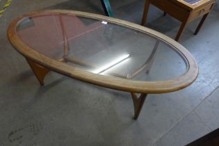 A Stonehill Stateroom teak and glass topped oval coffee table