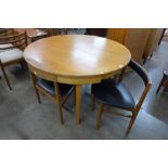 A teak extending dining table and four chairs
