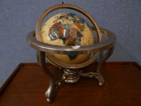 A faux gemstone desk top terrestrial globe on stand
