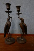 A pair of French bronze figural stork candlesticks