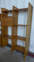 A Staples teak Ladderax two bay room divider, with stool