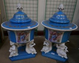 A pair of large continental figural cherub porcelain pots and covers