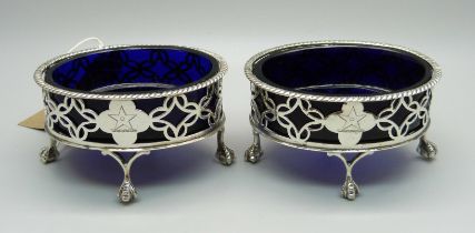 A pair of Victorian silver salt cellars with blue glass liners, London 1884, weight of bases 98g