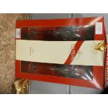 A bottle of G.H. Mumm Champagne and two Champagne glasses, boxed