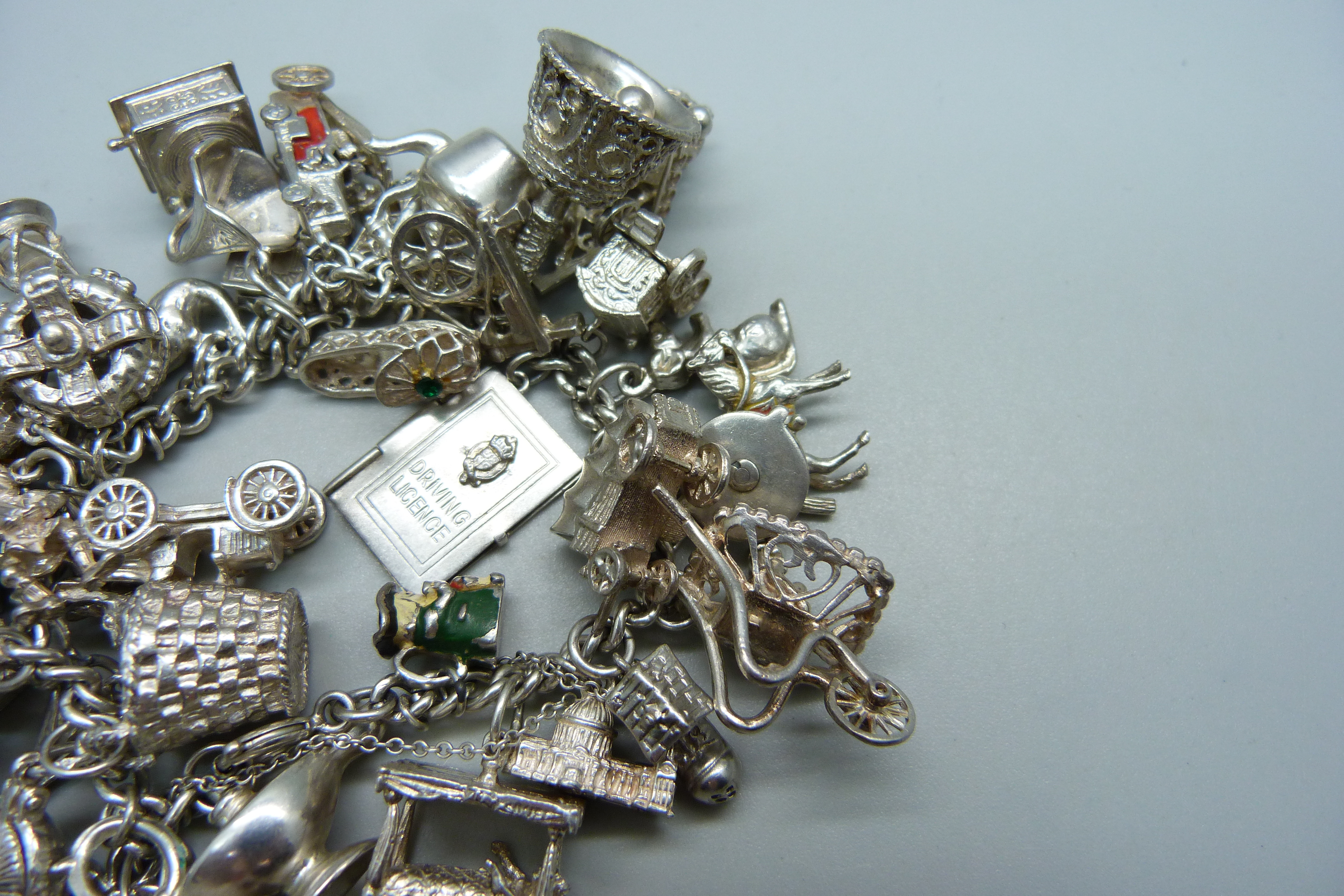 A silver bracelet with over 30 silver and white metal charms, 132g - Image 4 of 4
