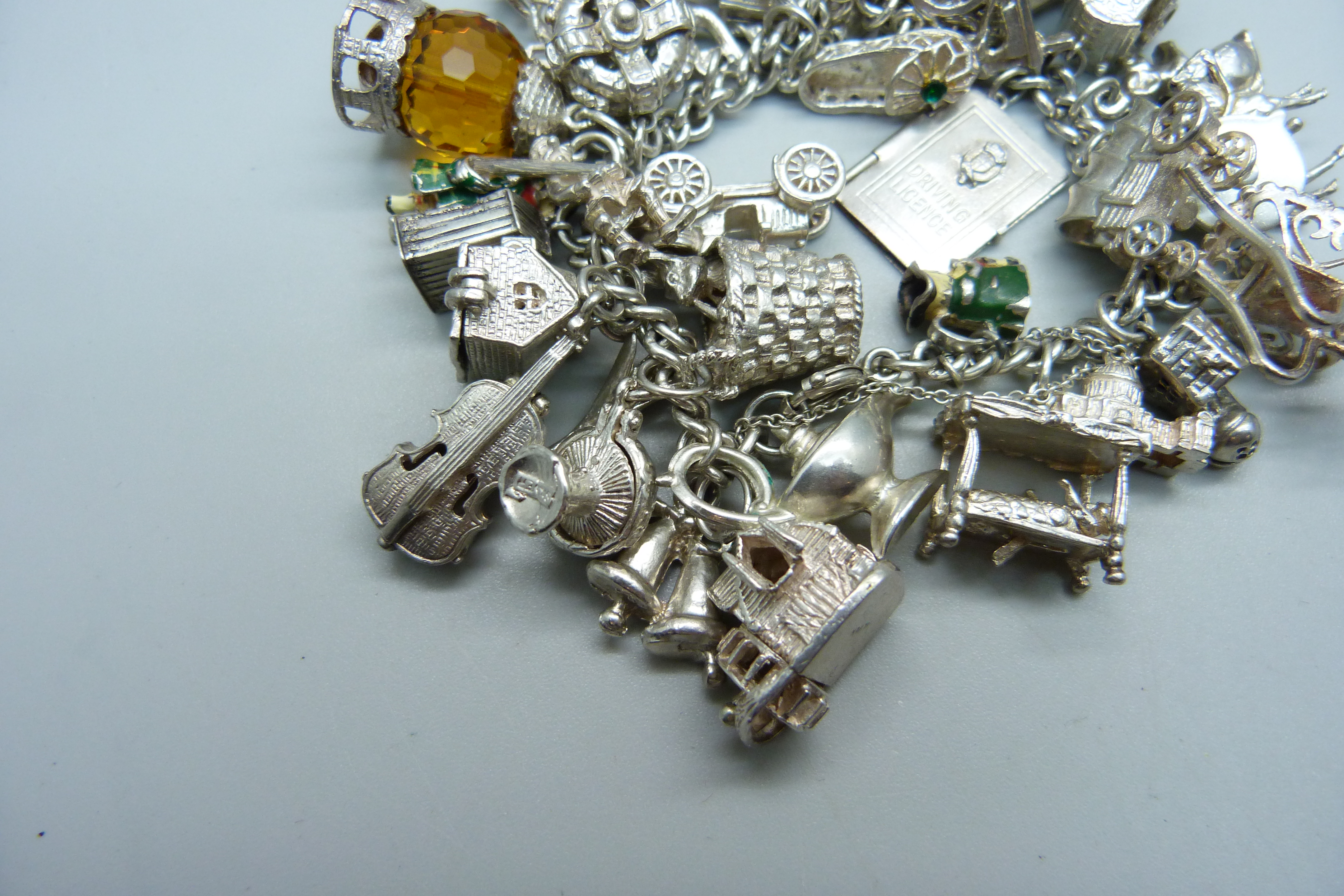 A silver bracelet with over 30 silver and white metal charms, 132g - Image 2 of 4