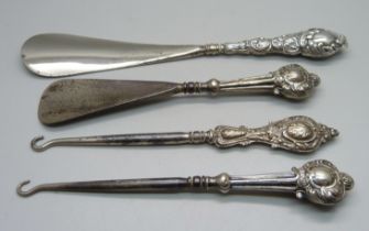 Two silver mounted shoe horns and two button hooks