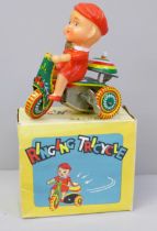 A small Chinese tin plate toy tricycle, boxed