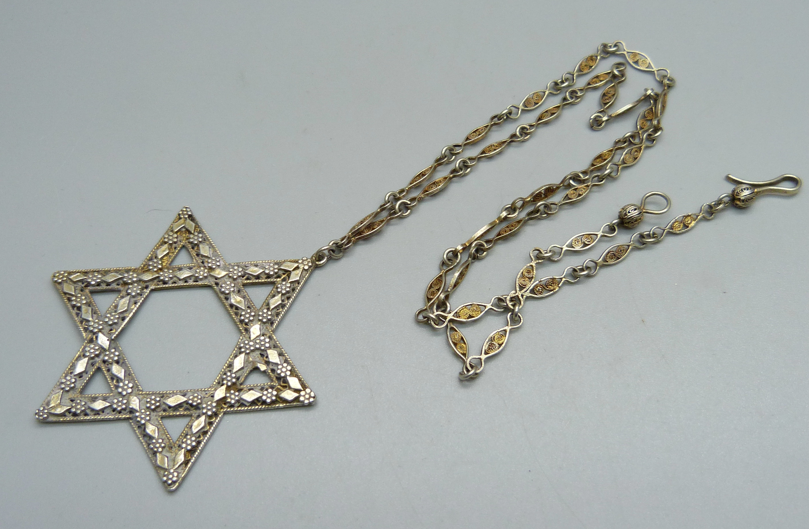 A silver Star of David pendant marked Israel and chain