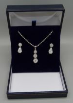 A 14ct white gold and diamond triple cluster drop pendant and chain and matching earrings (silver