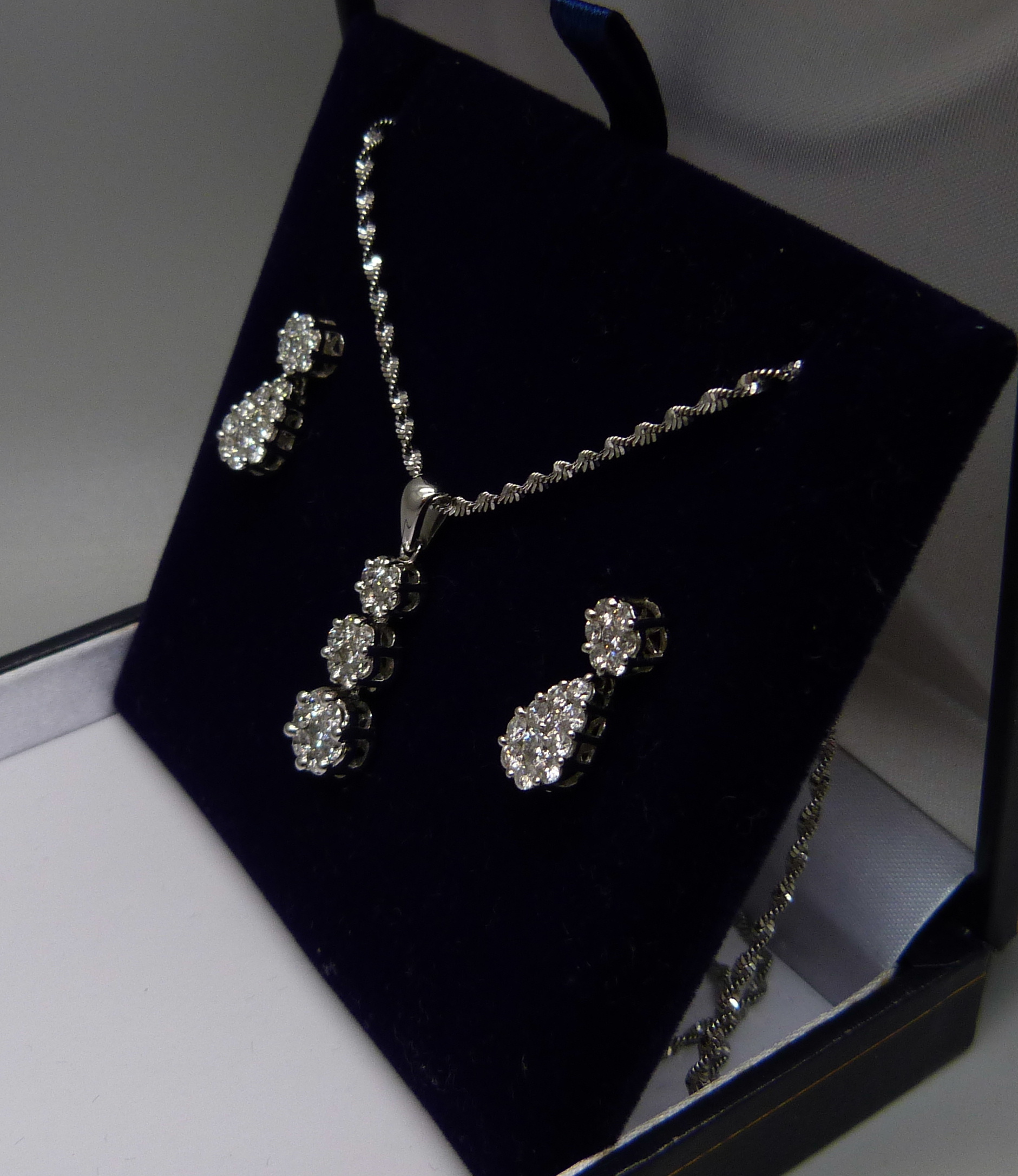 A 14ct white gold and diamond triple cluster drop pendant and chain and matching earrings (silver - Image 3 of 3