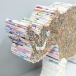 A rhinoceros artwork made from rolled magazine cuttings, 57cm