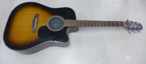 A Takamine classical guitar with a hard case and CT-4BII active pre-amp