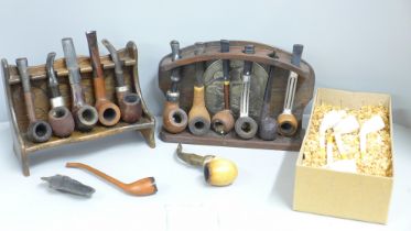 Thirteen pipes, two pipe racks and a box of clay pipes