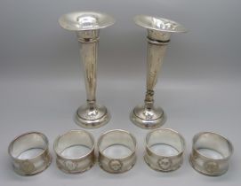 A pair of silver vases, a/f, and five plated napkin rings