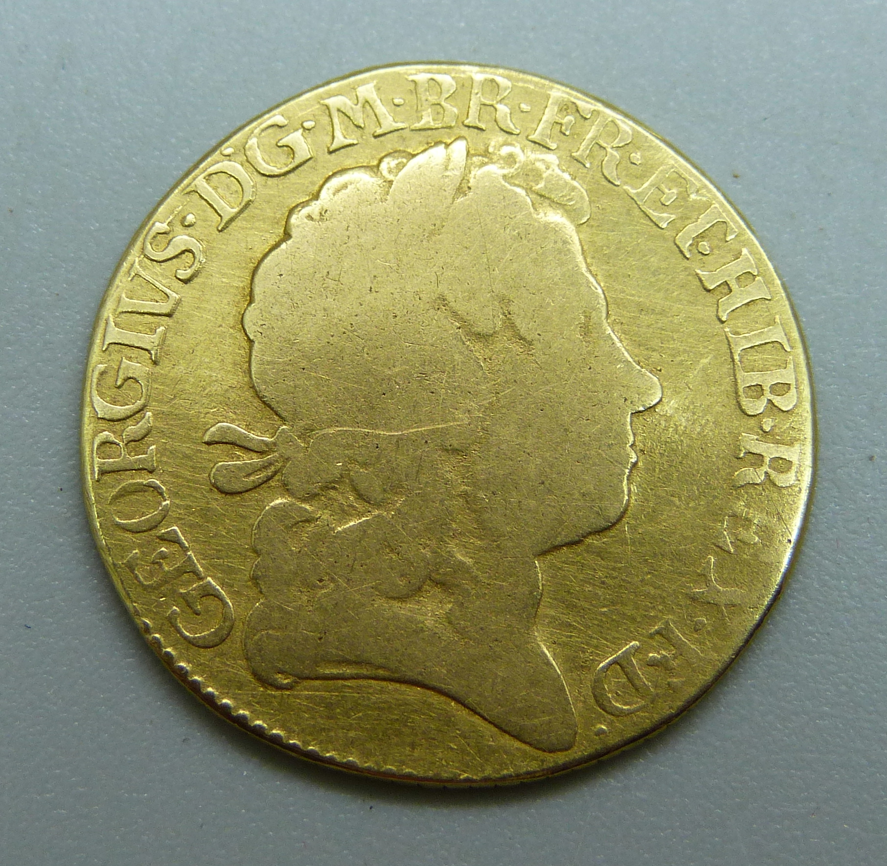A George I 1719 gold guinea, worn, edge re-milled, 7.1g,