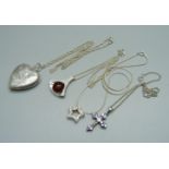 A silver locket and chain and three silver pendants and chains, 28g