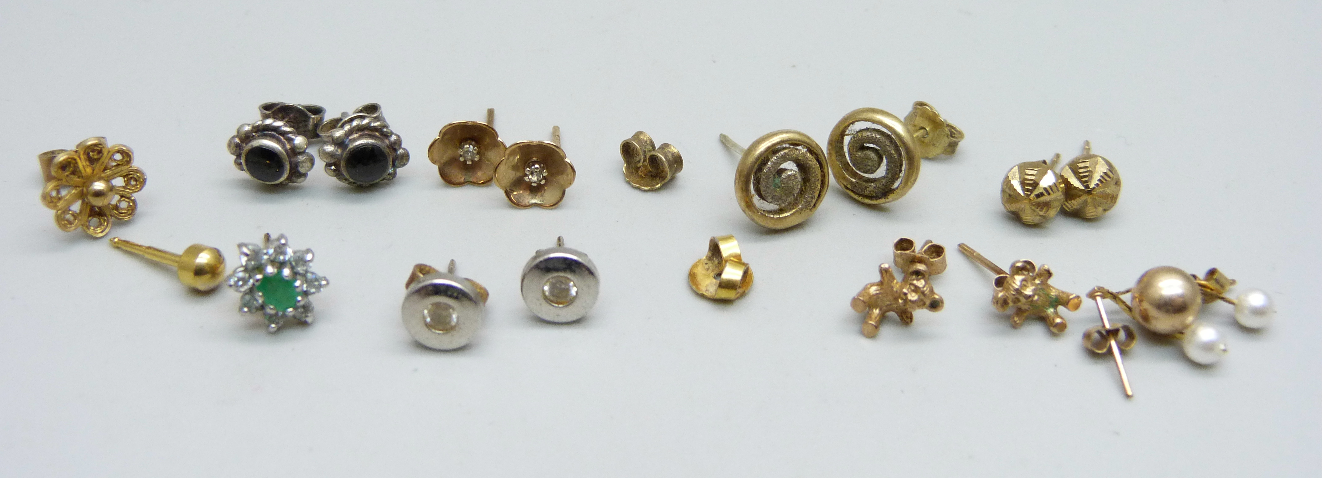 Six pairs of earrings and five single earrings, including one pair marked 9ct gold, 0.5g, and one