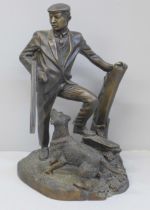 A cast metal sculpture of a gamekeeper and his dog