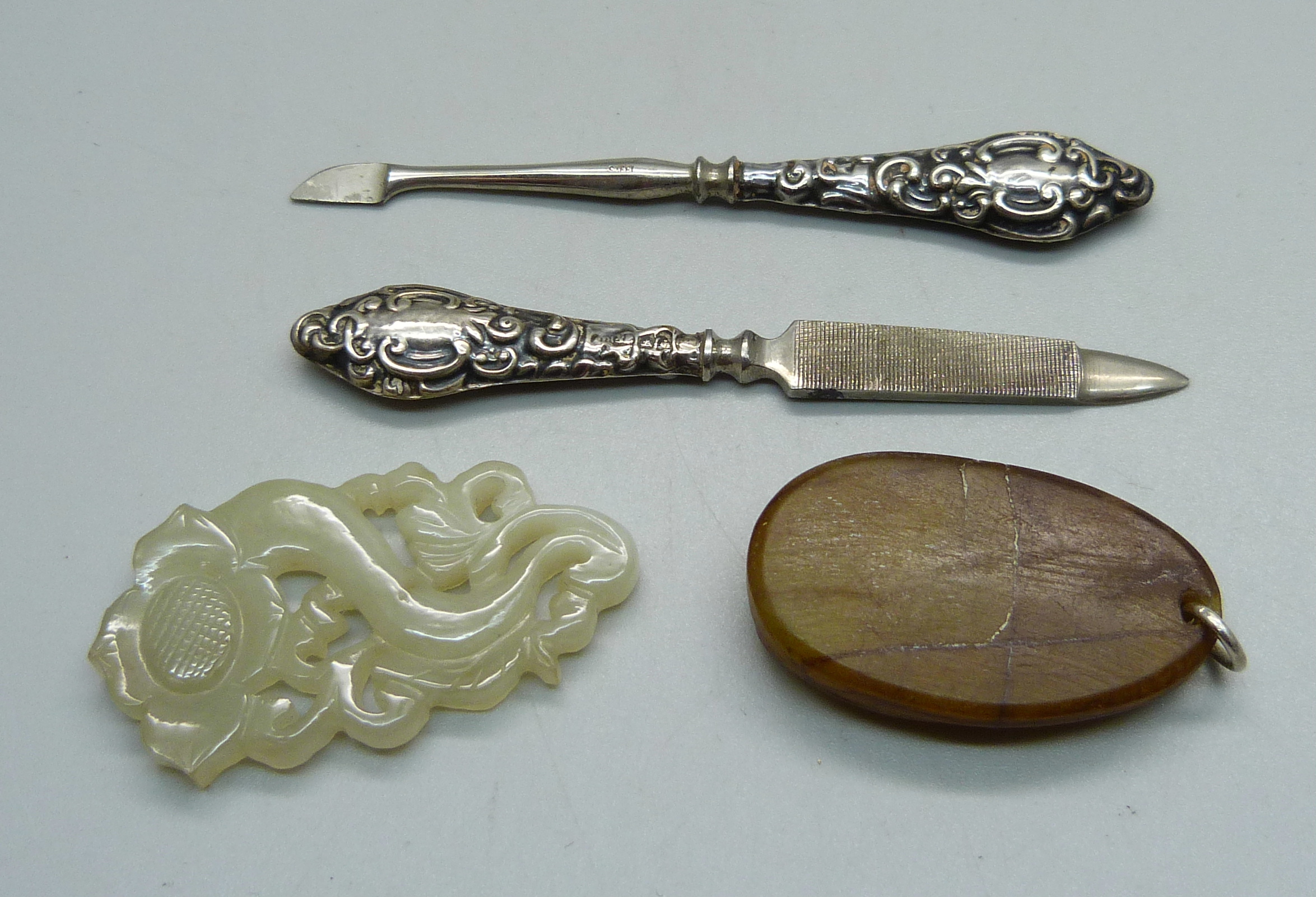 A carved jade pendant, one other pendant and two silver mounted manicure tools - Image 2 of 2