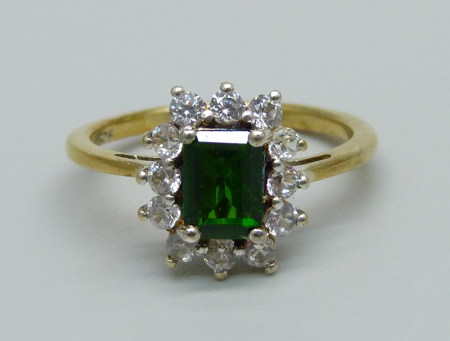 A silver gilt, green and white stone cluster ring, P