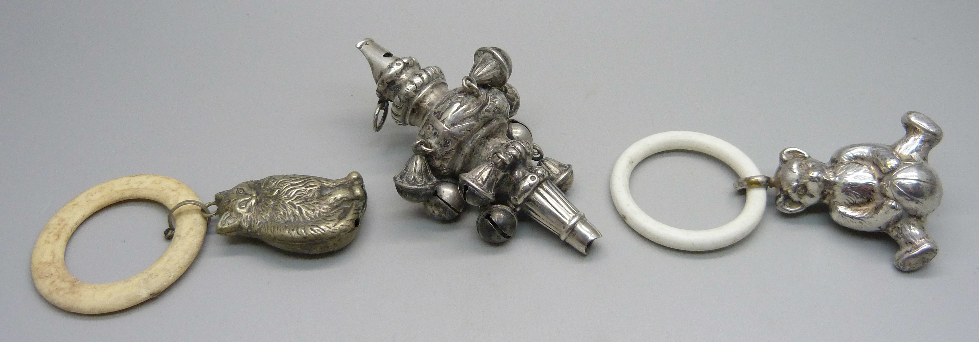 A Victorian silver rattle/whistle, Birmingham 1896, a Teddy bear rattle and a cat rattle