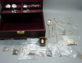 A collection of silver jewellery including a garnet and opal cluster ring, a silver thimble and a