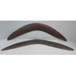 Two carved wooden boomerangs, one a/f