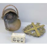 A brass military trivet, 1900s registration number, RD 362481, a WWII matchbox cover souvenir and