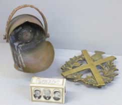A brass military trivet, 1900s registration number, RD 362481, a WWII matchbox cover souvenir and