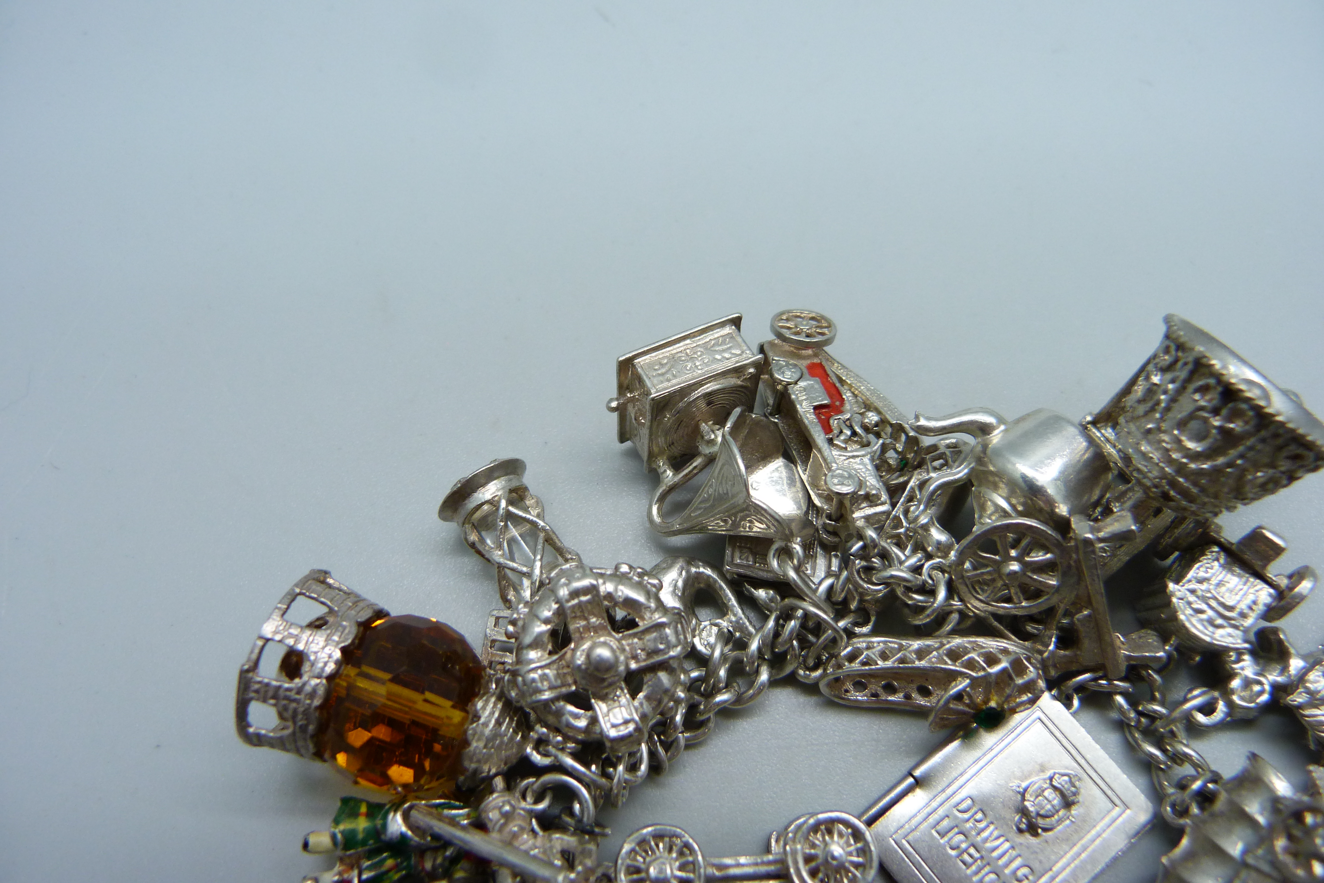 A silver bracelet with over 30 silver and white metal charms, 132g - Image 3 of 4