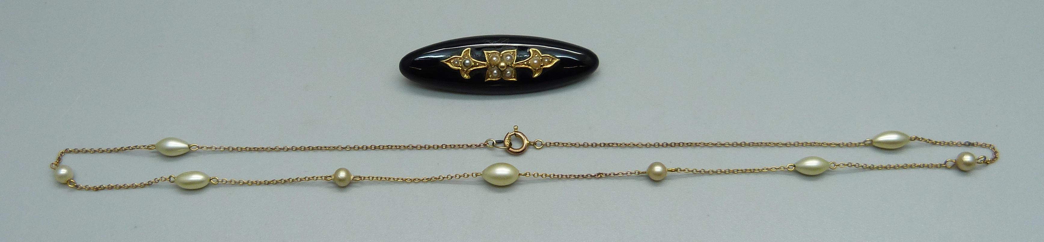 A Victorian mourning brooch set with seed pearls and a fine 9ct gold and pearl necklace, (very small