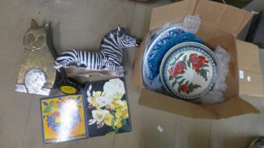 A box of assorted pottery, including a figure of a zebra, a Surrealist style cat, etc.