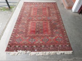 A Belgian terracotta ground rug, 300 x 200cms
