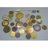 A collection of badges, medallions and tokens