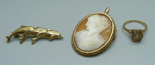 A 9ct gold dolphin brooch, 1.4g, a 9ct gold mounted cameo brooch, 9.8g, and a yellow metal ring, 2.